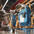 Robotic arms assembling blue car door on factory assembly line