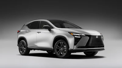 White Lexus UX compact crossover SUV displayed against neutral gray background