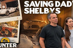Two people examining vintage Shelby race cars in a garage with Barn Find Hunter logo