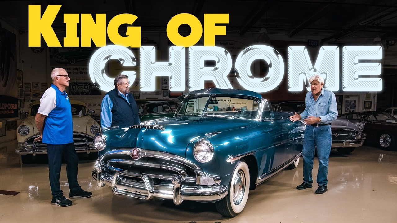 Three men stand beside a restored turquoise 1950s convertible car in a showroom with 'King of Chrome' text overlay