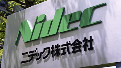 NIDEC Corporation green logo sign with Japanese text on outdoor wall