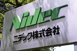 NIDEC Corporation green logo sign with Japanese text on outdoor wall