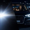 Woman driving black SUV at night on highway with oncoming headlights