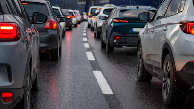Heavy traffic congestion on a multi-lane highway with vehicles stopped bumper-to-bumper during rush hour.