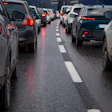 Heavy traffic congestion on a multi-lane highway with vehicles stopped bumper-to-bumper during rush hour.