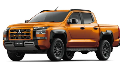 Orange Mitsubishi Triton pickup truck shown in profile view against white background