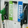 Green and blue fuel pump nozzles labeled Petrol and Diesel at a gas station dispenser