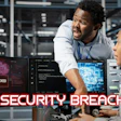 Two cybersecurity professionals monitoring computer screens displaying system hacked alerts and code in a data center environment