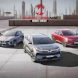 Five VinFast electric vehicles displayed on a rooftop with city skyline backdrop and Manufacturing Now branding