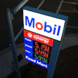 Mobil gas station price sign displaying fuel prices with Synergy branding and Food Mart services