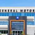 General Motors corporate headquarters building with blue glass windows and GM logo signage