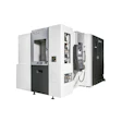 OKUMA CNC machining center with white and black exterior, doors open showing internal mechanical components and control panels