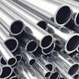 Stacked polished metal tubes and pipes arranged diagonally showing circular openings and reflective surfaces