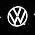 Volkswagen logo emblem illuminated against dark background